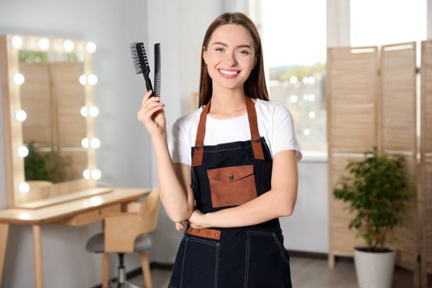 Portrait of happy hairdresser with comb and brush in beauty salon SEO Services For Salon Business